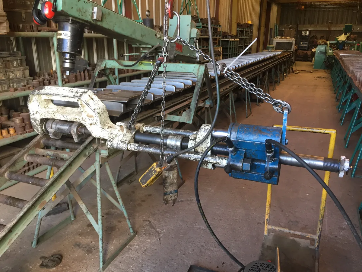 Portable pin press at work on a track chain